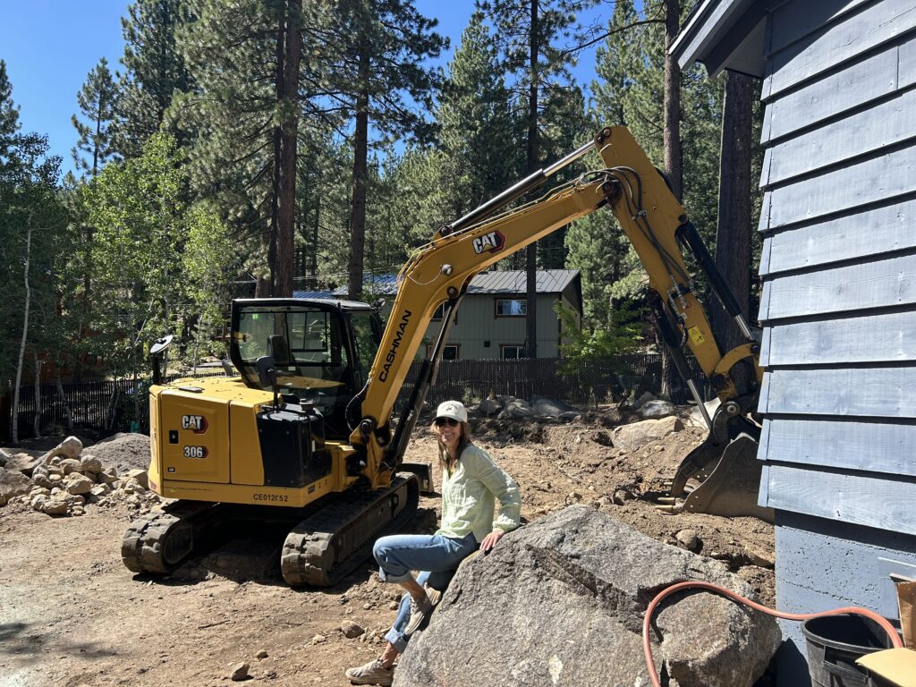 Homeowner with excavator in the background.